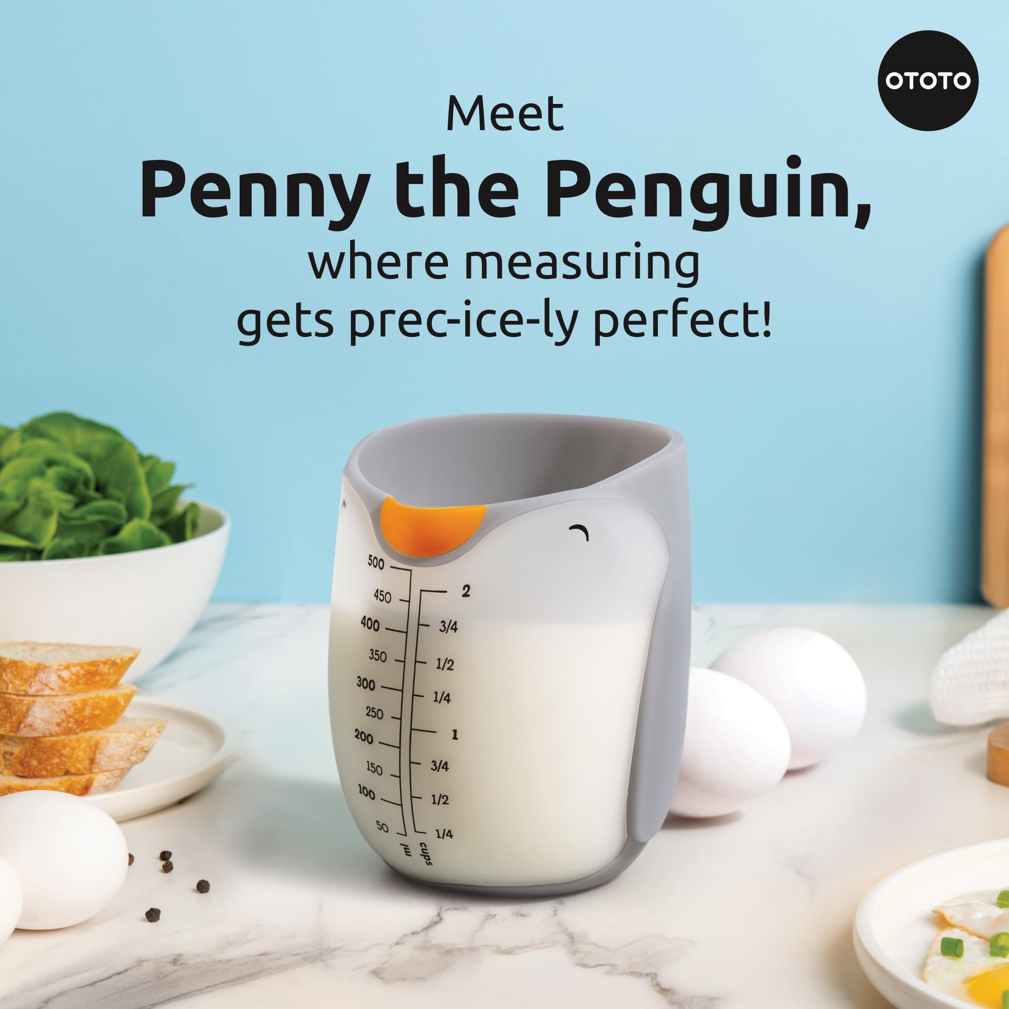 OTOTO Penny Penguin measuring cup showing the pour spout for controlled pouring.