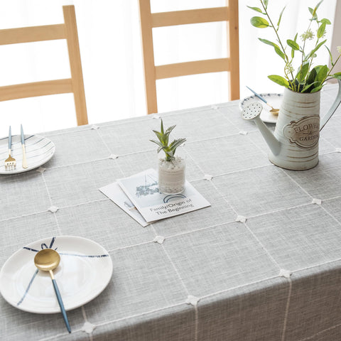 Oubonun grey tablecloth close-up demonstrates waterproof coating for quick cleanups
