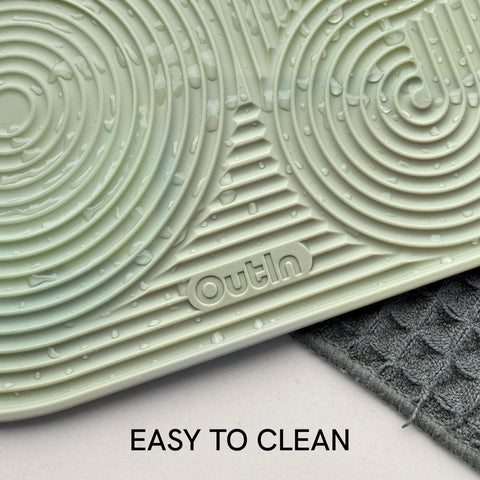 OutIn silicone coffee mat ideal for travel and portable coffee setups.