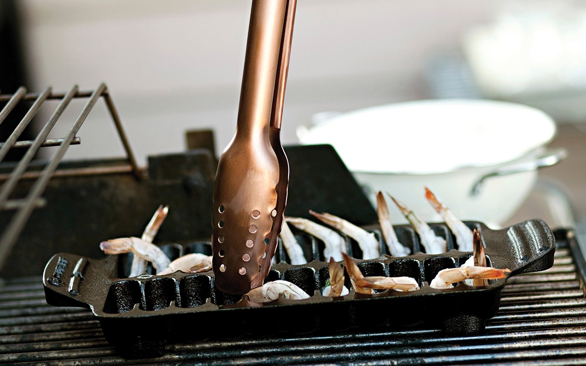 Outset pan shown on grill delivering even heat for grilling