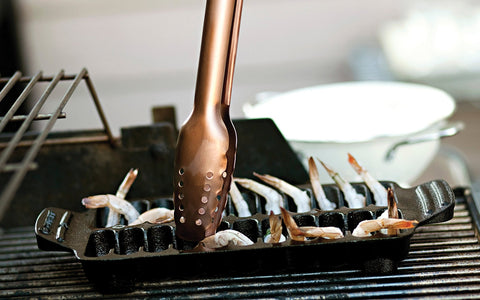 Outset pan shown on grill delivering even heat for grilling