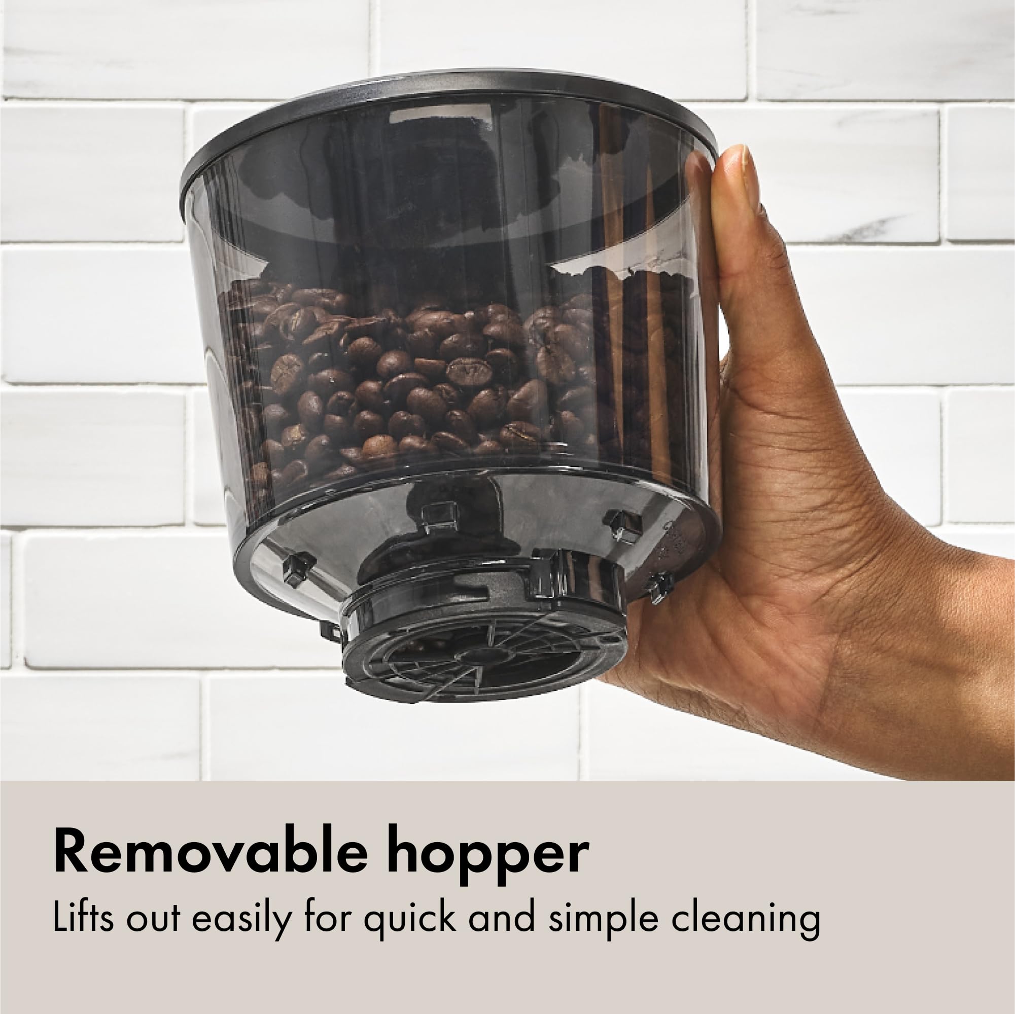 OXO Brew grinder trap door feature preventing bean spills during hopper removal.