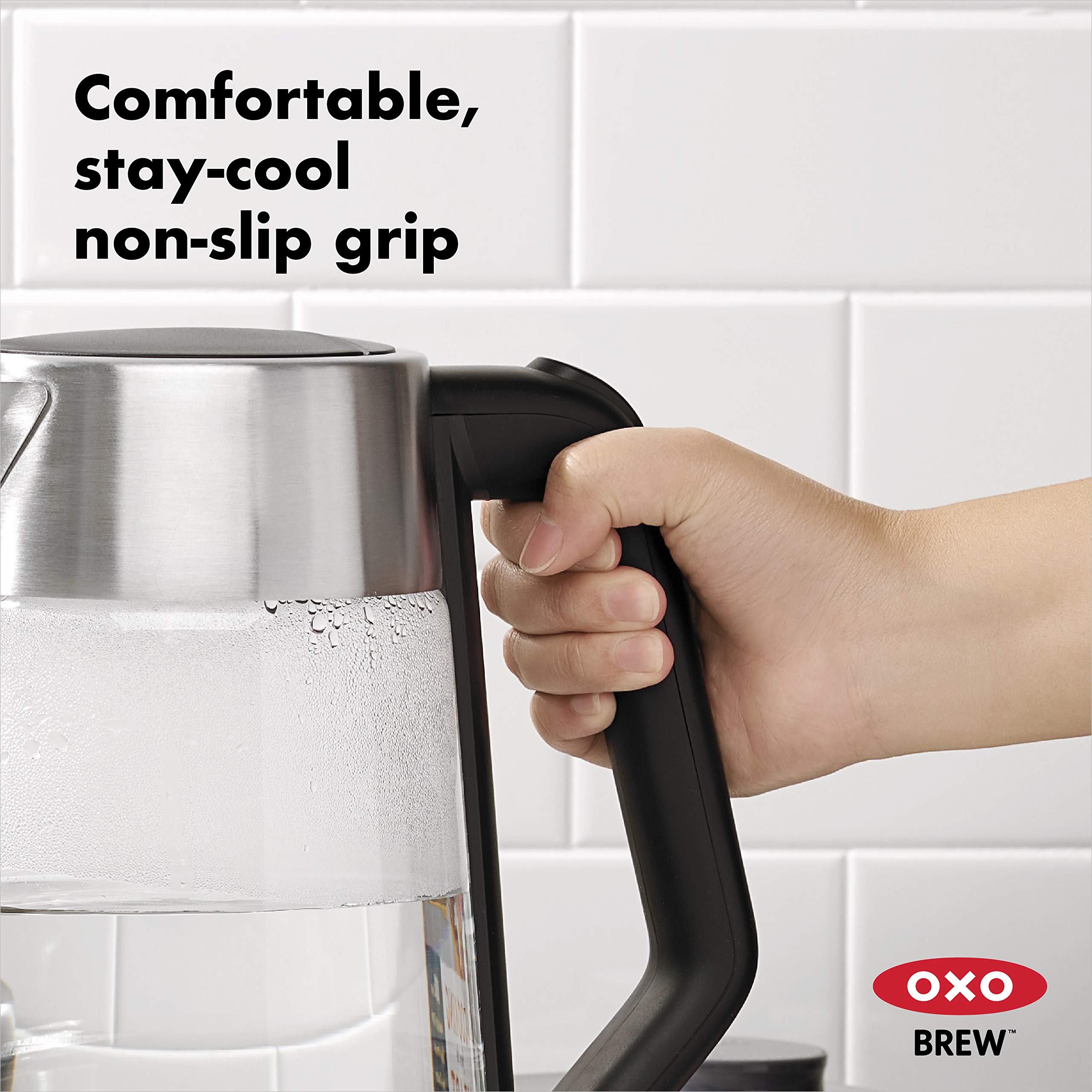 OXO Brew cordless glass kettle illuminated power switch indicates active heating.