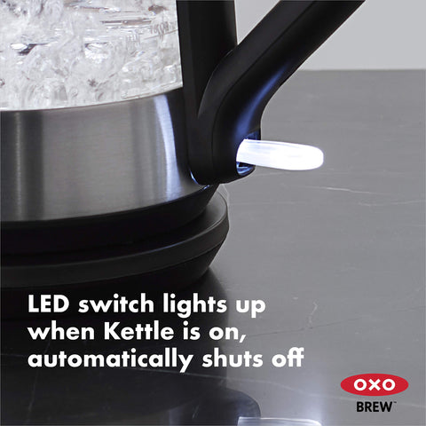 OXO Brew cordless glass kettle top view with measurement marks visible.