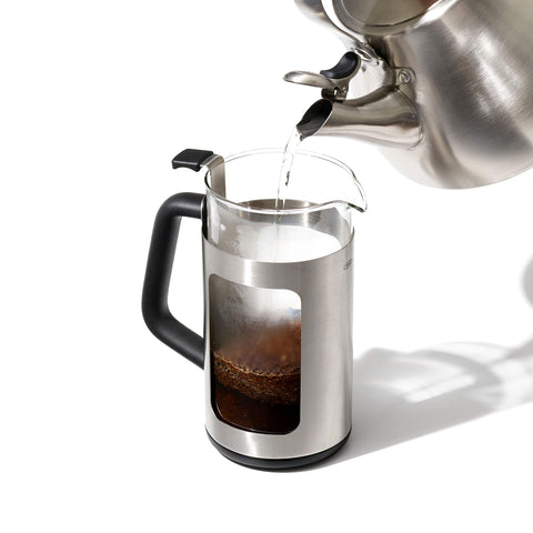 Pouring brewed coffee into a mug for a satisfying pour.