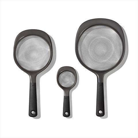 OXO Good Grips 3-Piece Strainer Set mini-strainer over a bowl catching pulp
