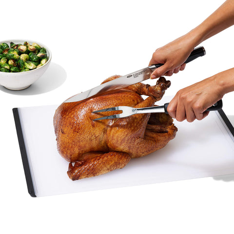 OXO Good Grips carving fork helping transport roasted meat from platter to plate
