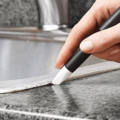 OXO Good Grips angled brush used for grout and flat surfaces in the kitchen