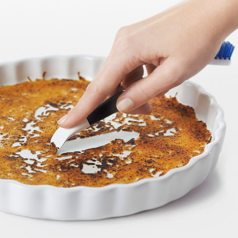 OXO Good Grips flat scraper lifts baked-on messes from stovetops