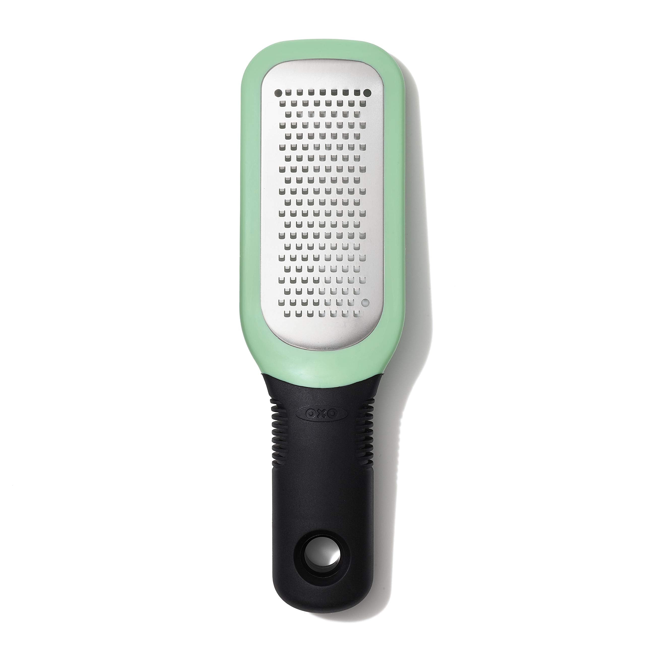 OXO Good Grips etched grater close-up shows sharp teeth for garlic and ginger paste.