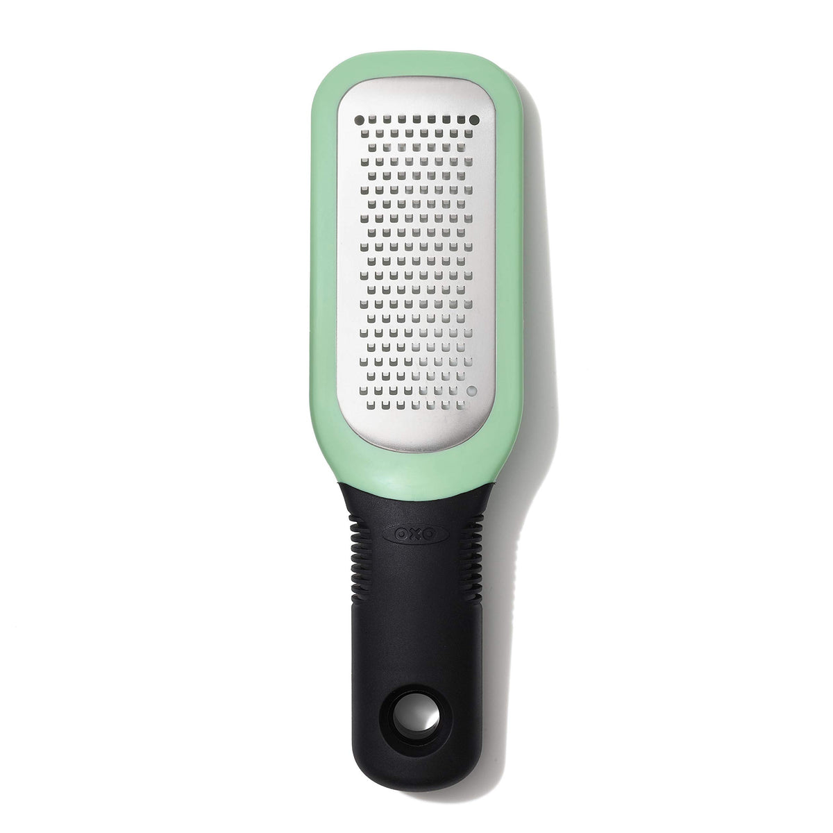 OXO Good Grips etched grater close-up shows sharp teeth for garlic and ginger paste.