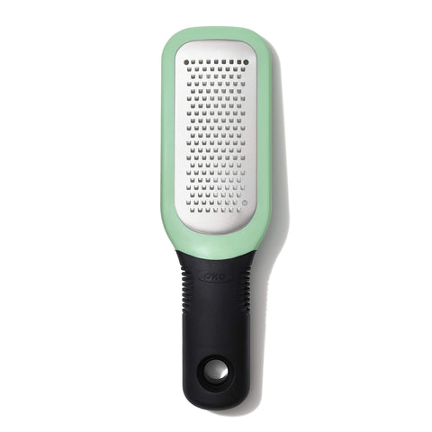 OXO Good Grips etched grater close-up shows sharp teeth for garlic and ginger paste.