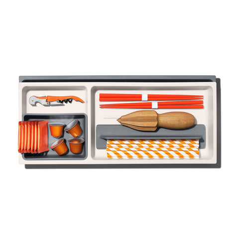 OXO Good Grips expandable drawer organizer shown in use within a busy kitchen.