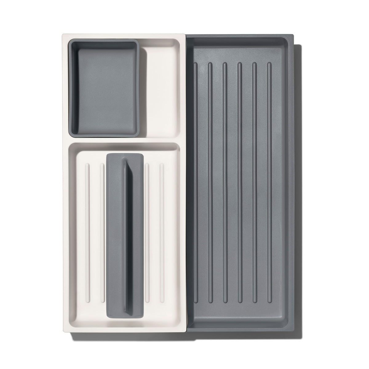 OXO Good Grips expandable drawer organizer top view showing flexible compartments for odd-shaped utensils.