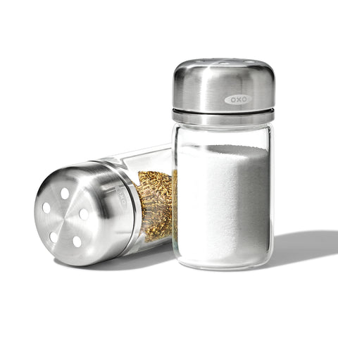 OXO Good Grips glass shaker close-up shows adjustable two-hole lid for precise seasoning.