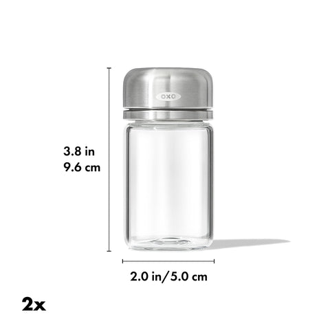 OXO Good Grips glass shaker in use with three-hole lid for controlled seasoning during cooking.