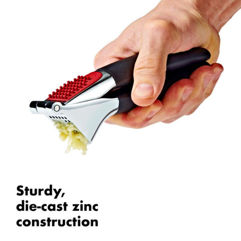 OXO Good Grips garlic press chamber close-up showing efficient holes for crushing cloves