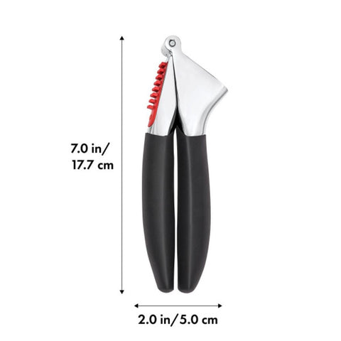 OXO Good Grips garlic press in-use view showcasing efficient garlic crushing