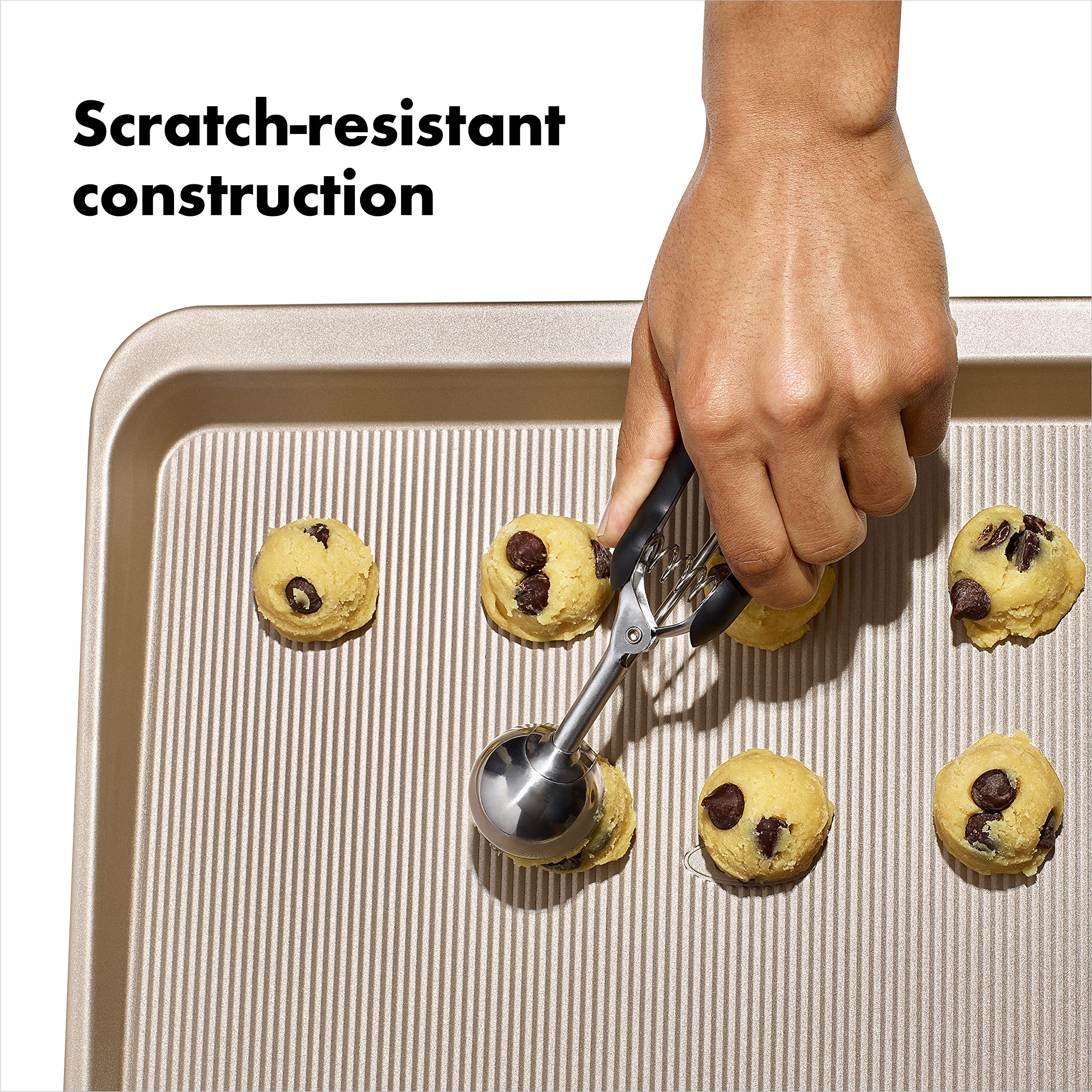 OXO Good Grips cookie sheet in hand is ready for transferring from the oven.