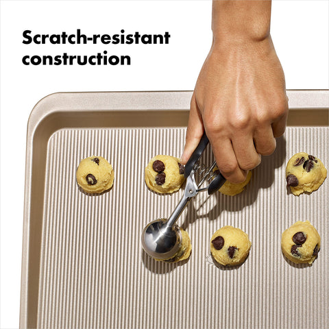 OXO Good Grips cookie sheet in hand is ready for transferring from the oven.