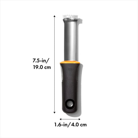 OXO Good Grips Peach Pitter close-up teeth gliding through fruit for clean pit removal.