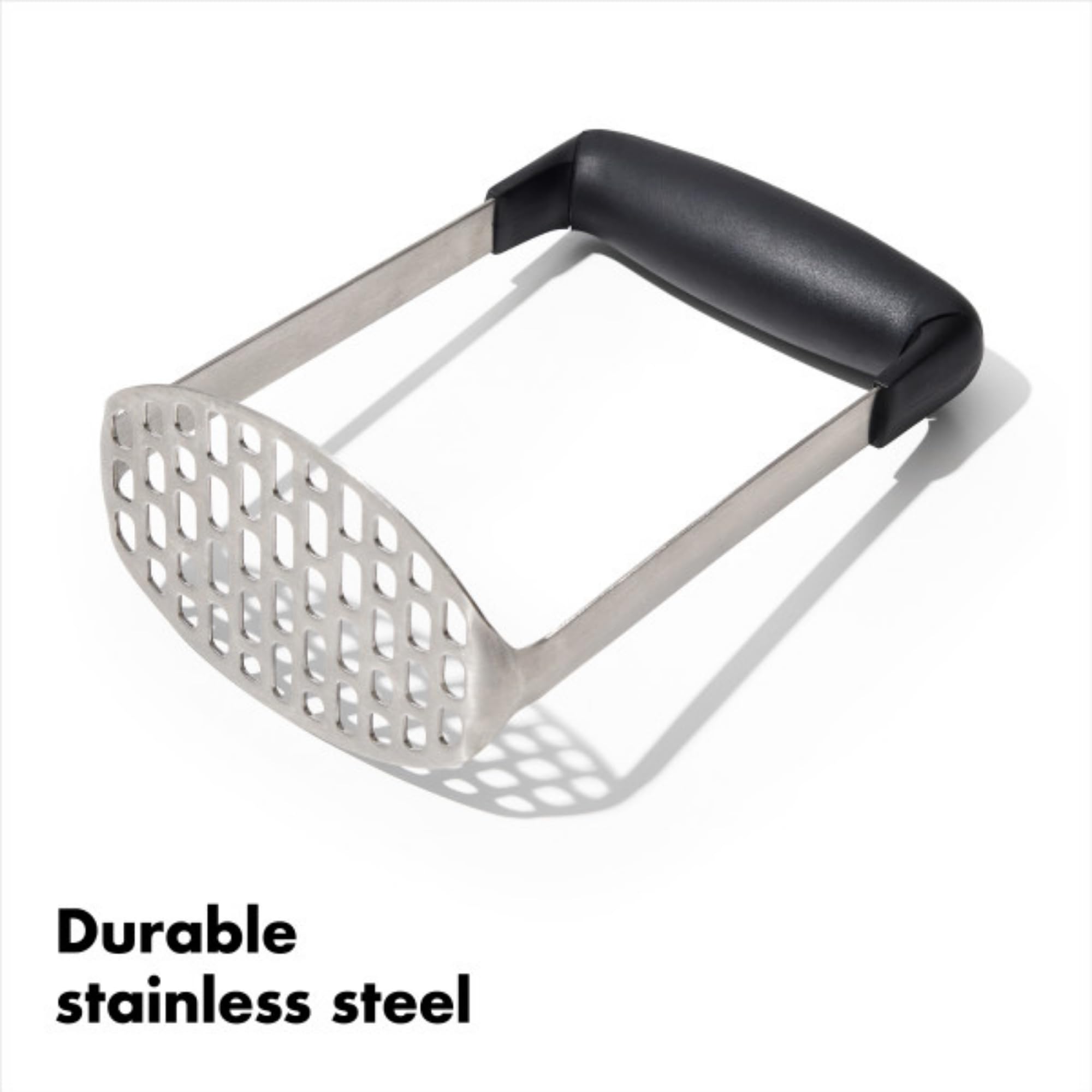 OXO Good Grips potato masher in use, pressing straight down with ease.
