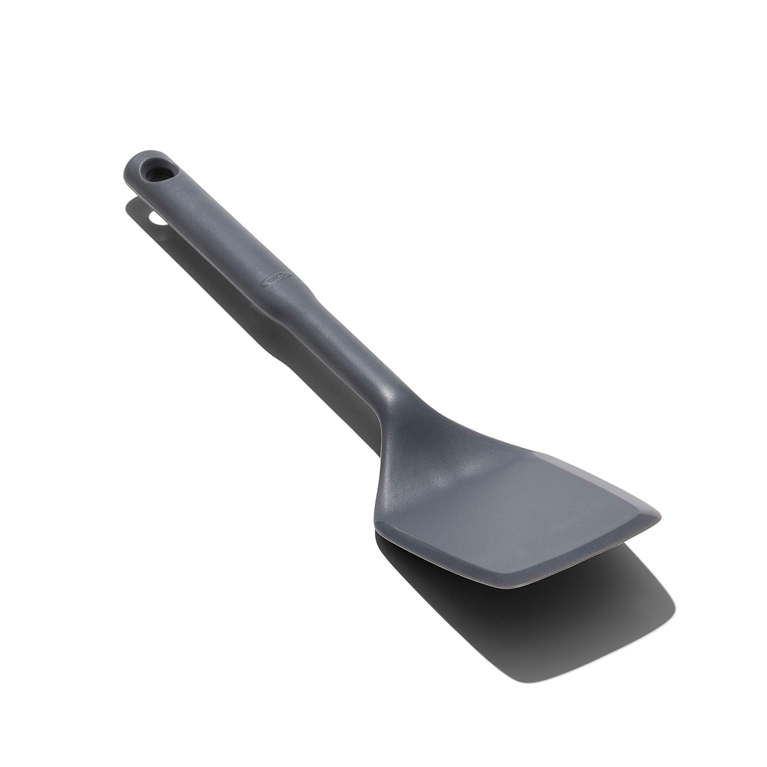 OXO Good Grips silicone flexible turner lifting food in hot pans without scratching non-stick cookware.