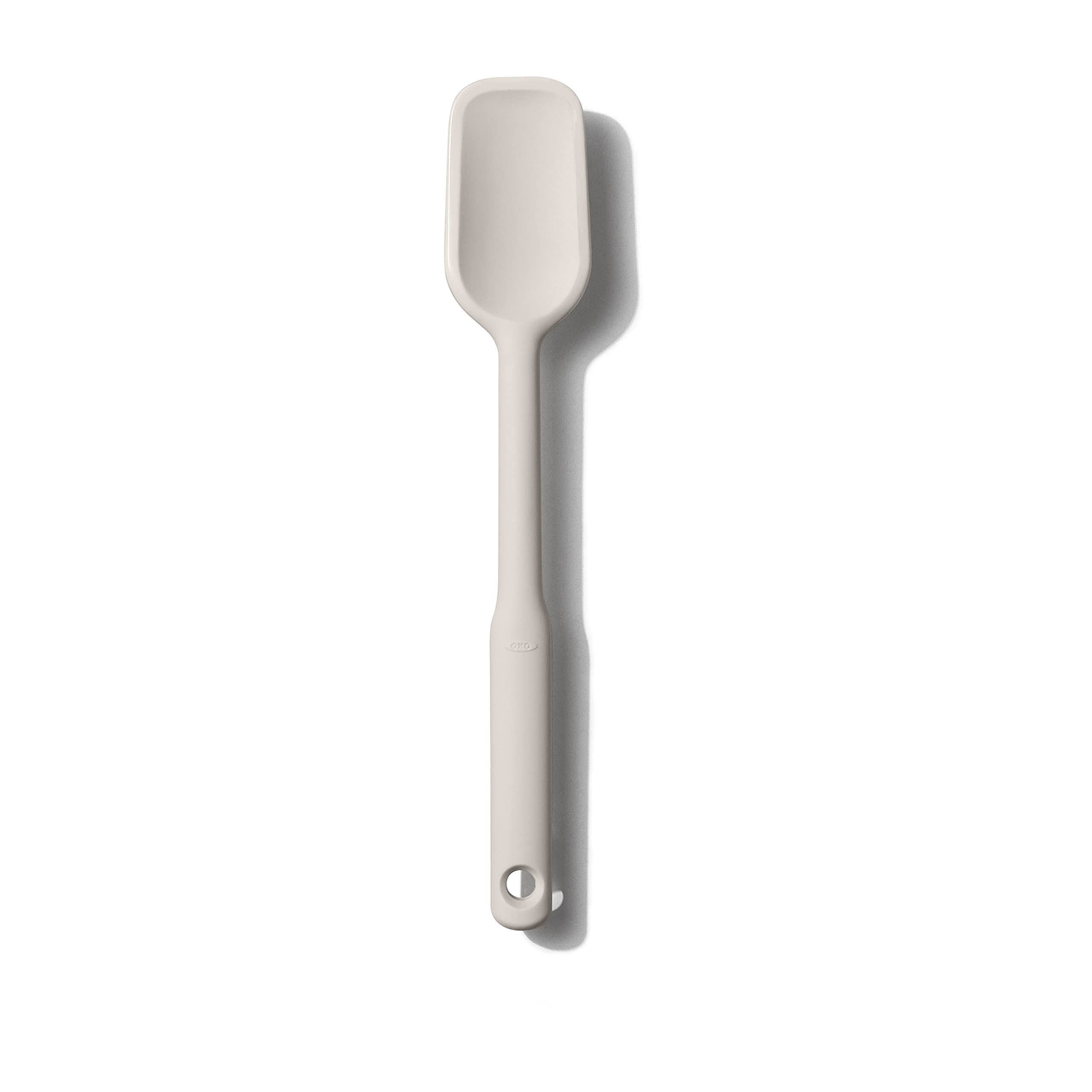 OXO Good Grips silicone spoon spatula with beveled edge for precise scraping.