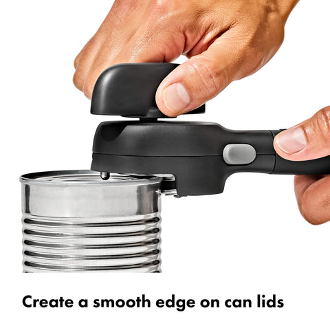 OXO Good Grips can opener with built-in lid pliers enabling contact-free lid removal