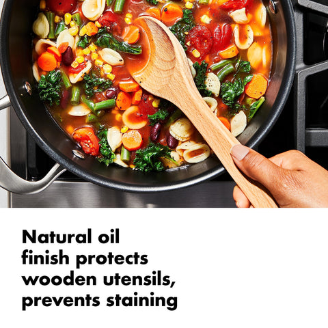 OXO Good Grips stainless steel tongs with silicone heads in action.