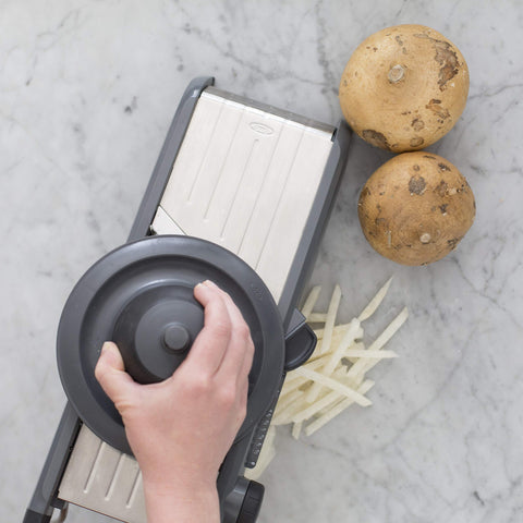OXO SteeL Chef's Mandoline 2.0 serrated blade glides through tomatoes and peppers smoothly.