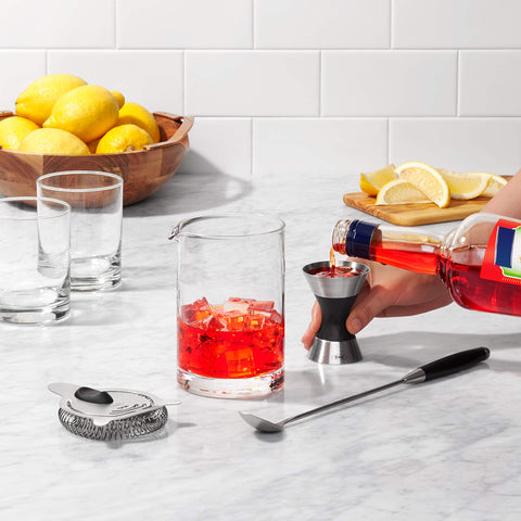 OXO SteeL jigger beside a shaker setup demonstrates dual-measure versatility.
