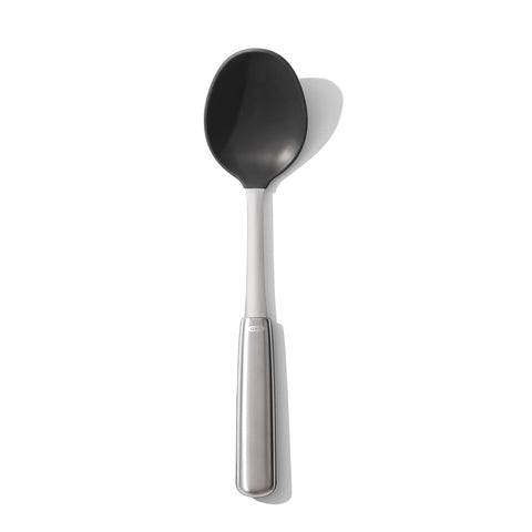 OXO steel silicone cooking spoon head close-up for safe non-stick stirring
