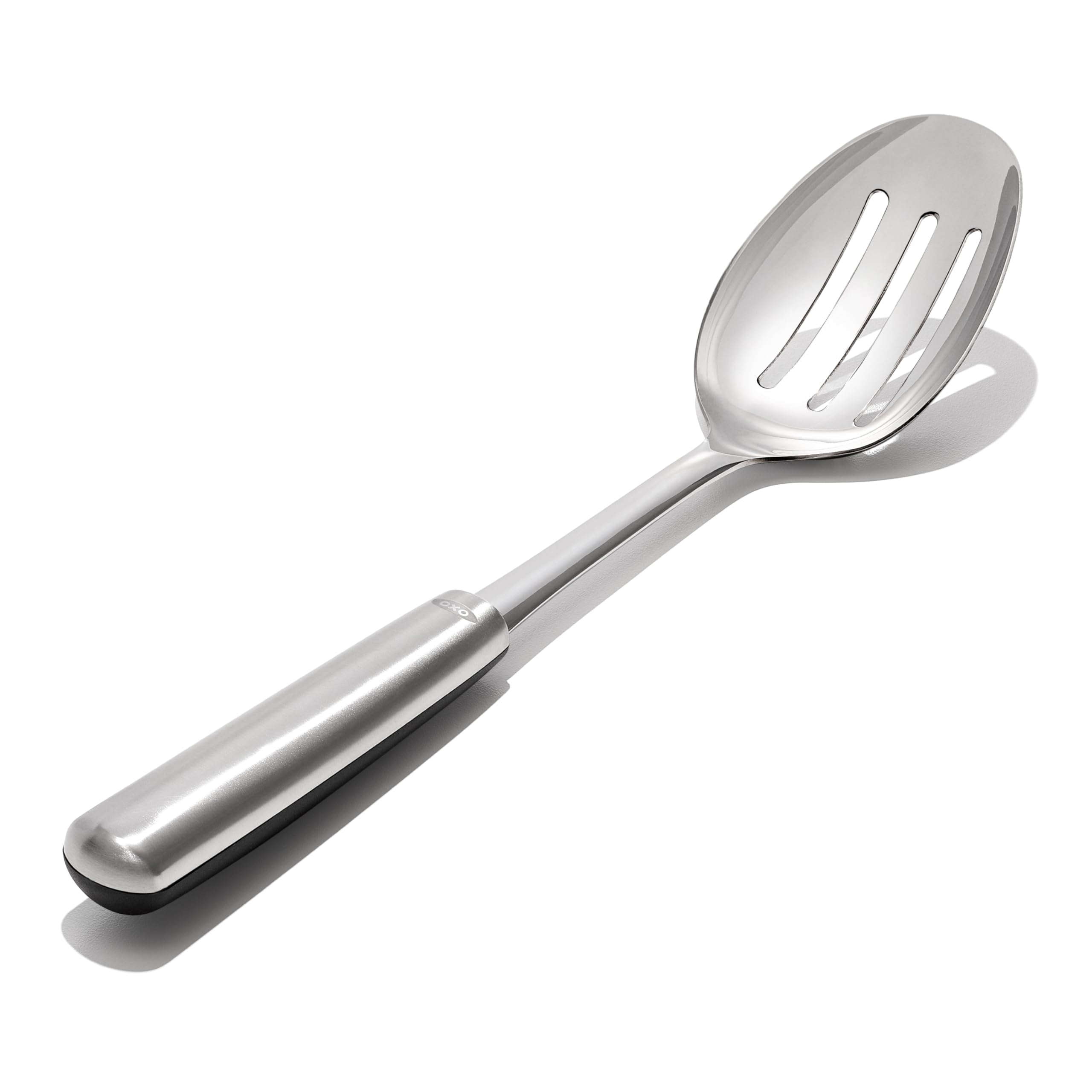 OXO spoon draining liquids through slots while lifting vegetables
