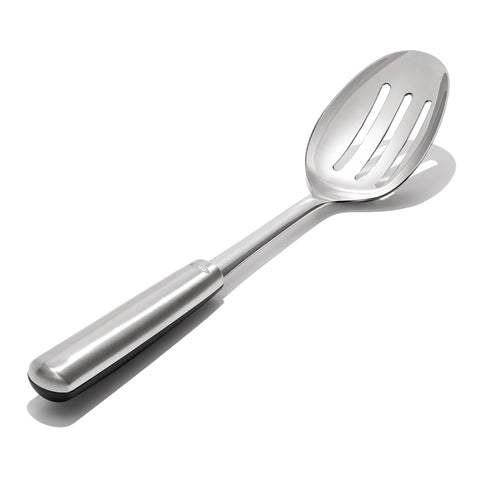 OXO spoon draining liquids through slots while lifting vegetables