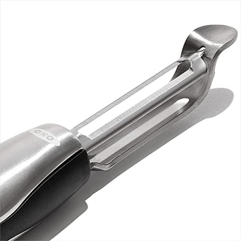 OXO Steel Swivel Peeler built-in eyer highlighted for quick blemish removal.