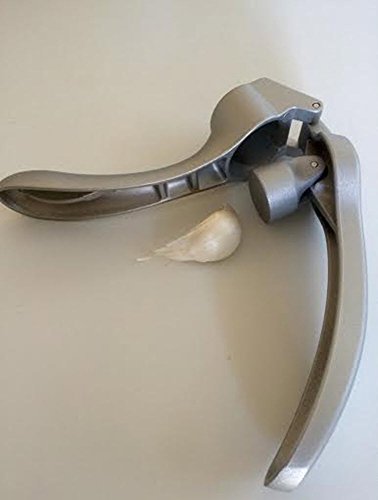 Pampered Chef garlic press with cleaning brush stored in ergonomic handle for quick cleanup