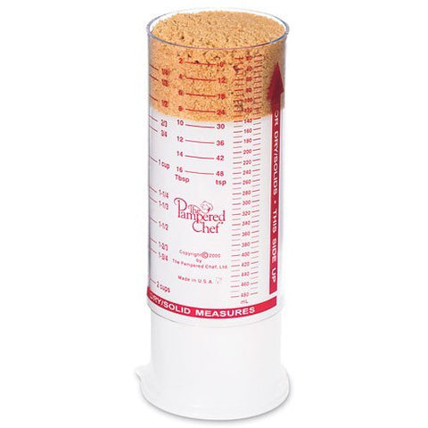 Clear Pampered Chef measuring cup shows metric and standard marks for easy prep.