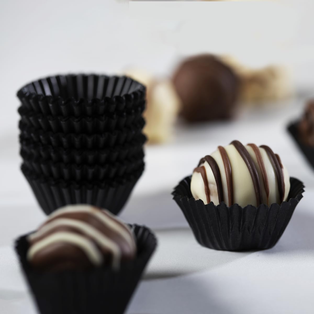 Pastry Chef's Boutique glassine chocolate black cups no4 for presenting chocolates with neat, clean handling.