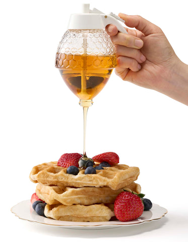 PAULSWAY honey dispenser with white lid enhances modern kitchen decor.