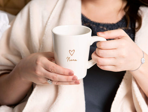 Pavilion Gift Company Nana Cup gift-ready with coordinating blankets and pillows.
