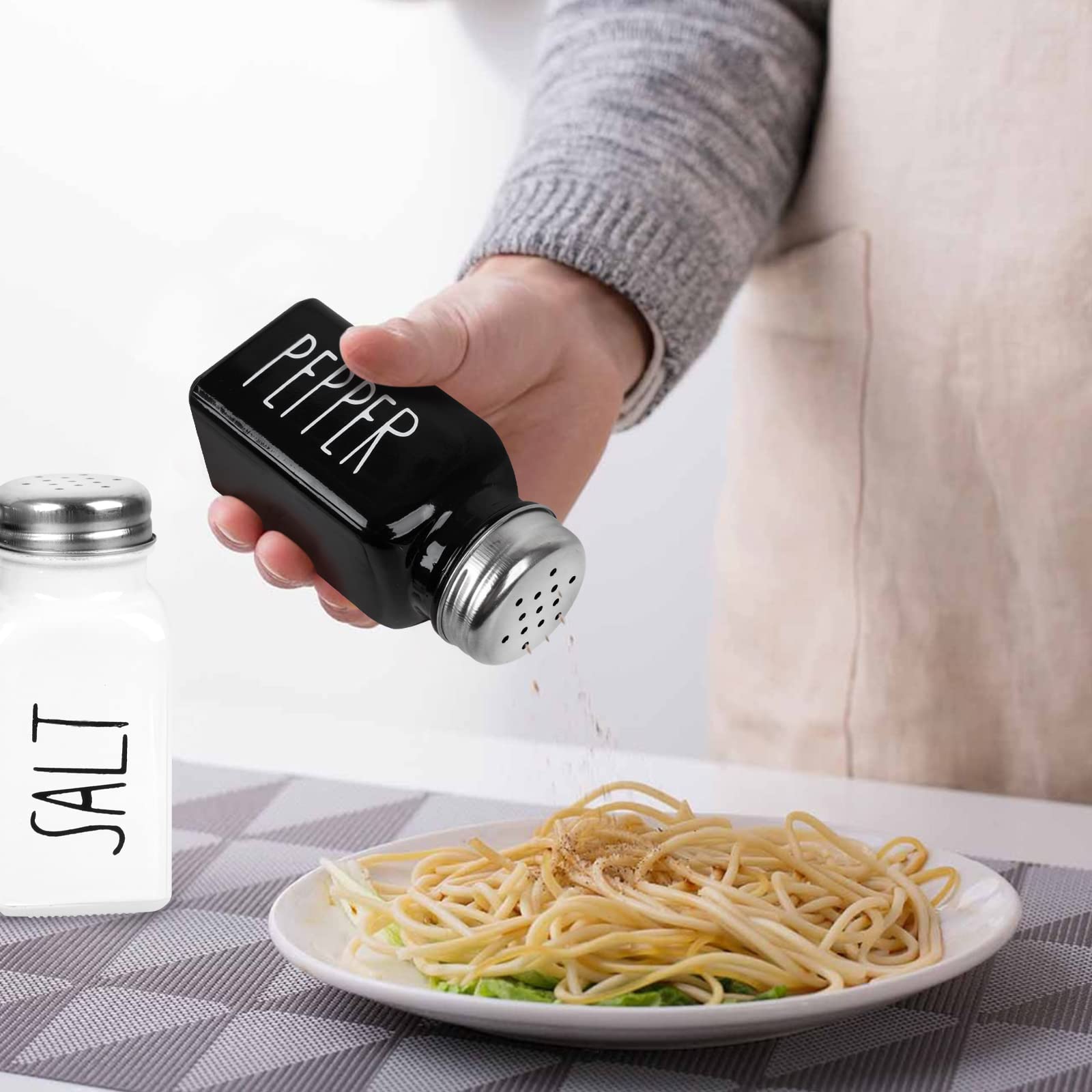 PECULA countertop display with black and white shaker set on table.