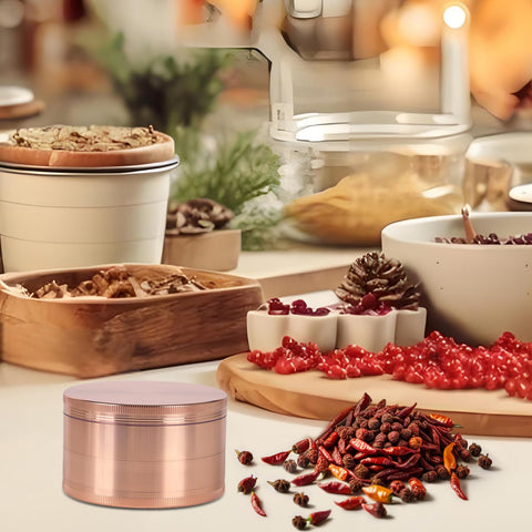 Perfekitsup rose gold spice grinder in use on a countertop