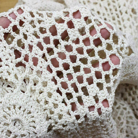 Phantomon lace table runner on coffee table enhances cozy ambience.