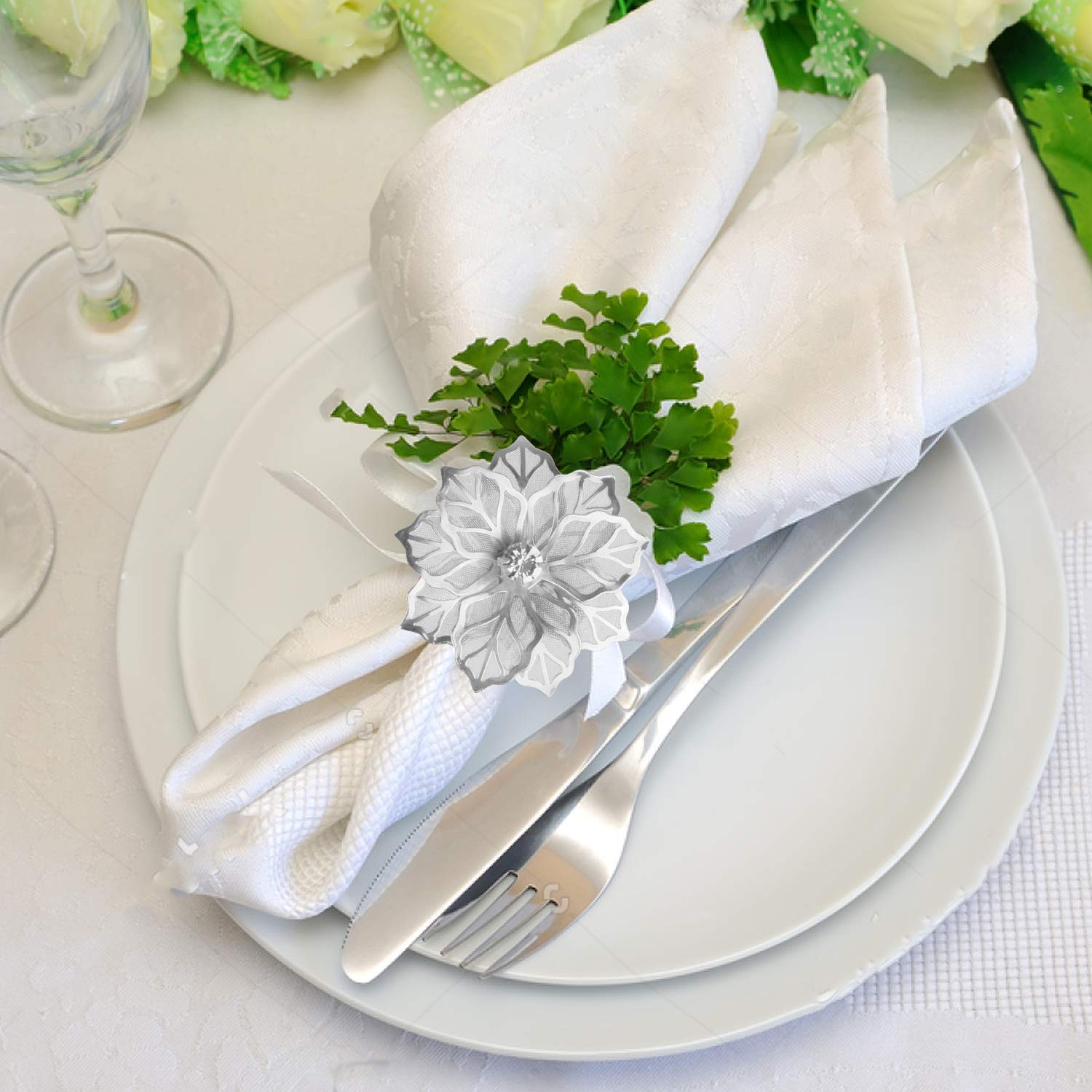 Picowe hollow flower napkin rings enhance wedding dinner table setup.