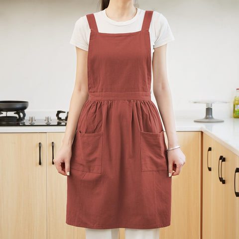 Pinknoke apron in garden setting for planting and cleaning tasks.