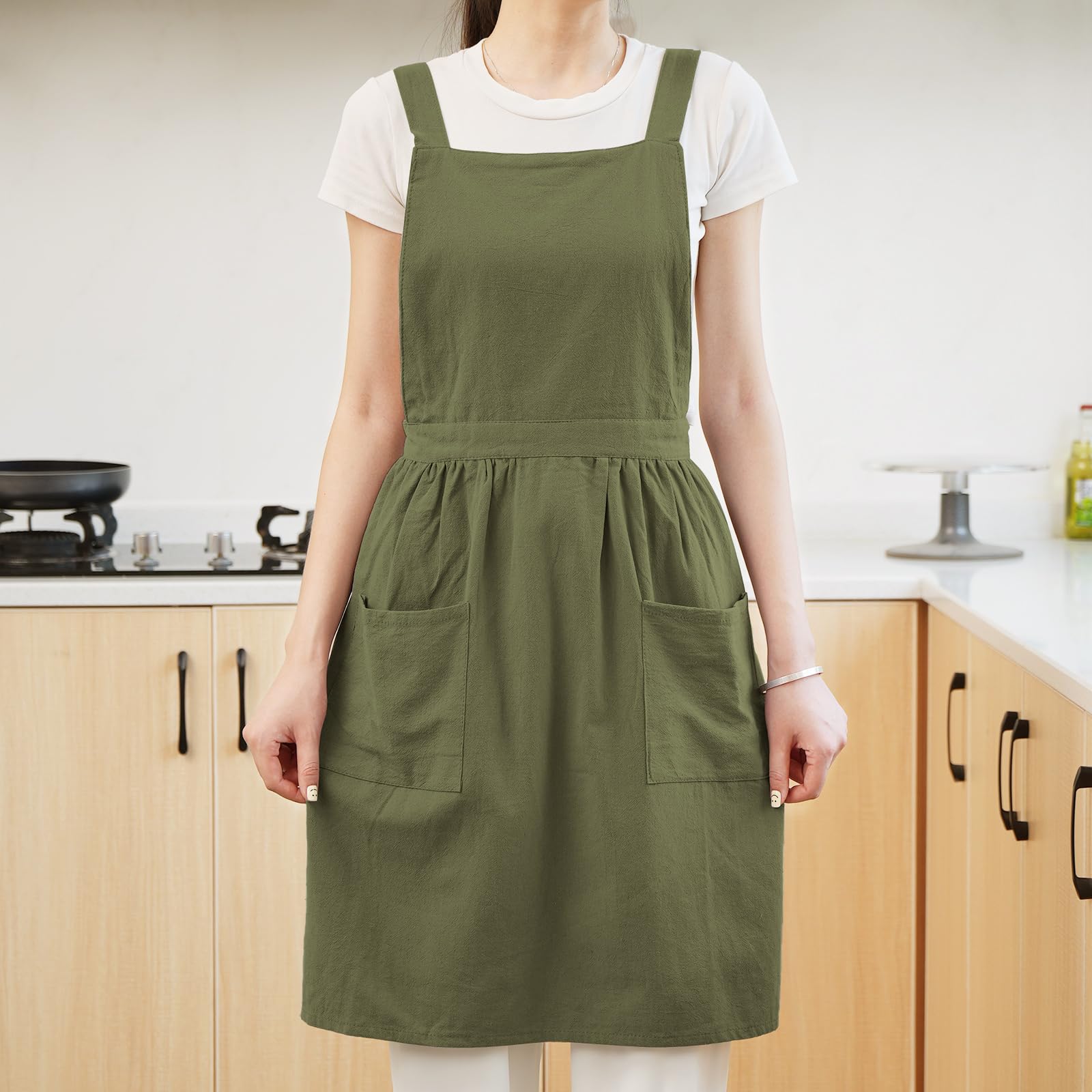 Pinknoke olive green apron used in garden or studio showing versatile multi-use design.