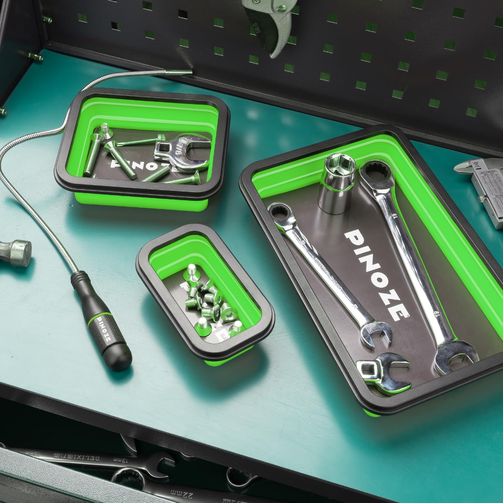 PINOZE magnetic pickup tool in use to grab bolts from a corner.