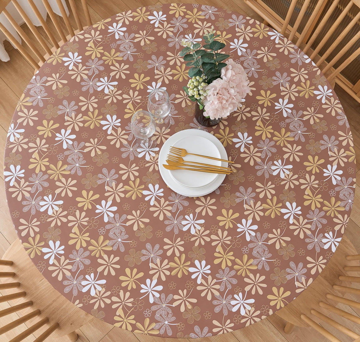 Pioggia round vinyl fitted tablecloth with elastic edge securing a 37-44 inch round table for meals