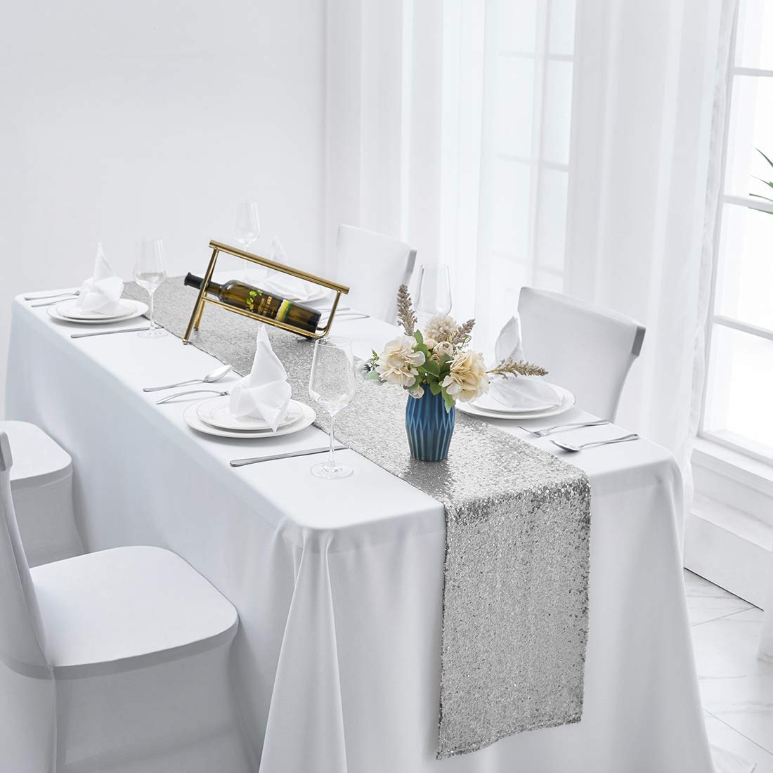 Pufogu baby shower table decor featuring silver sequin runner.